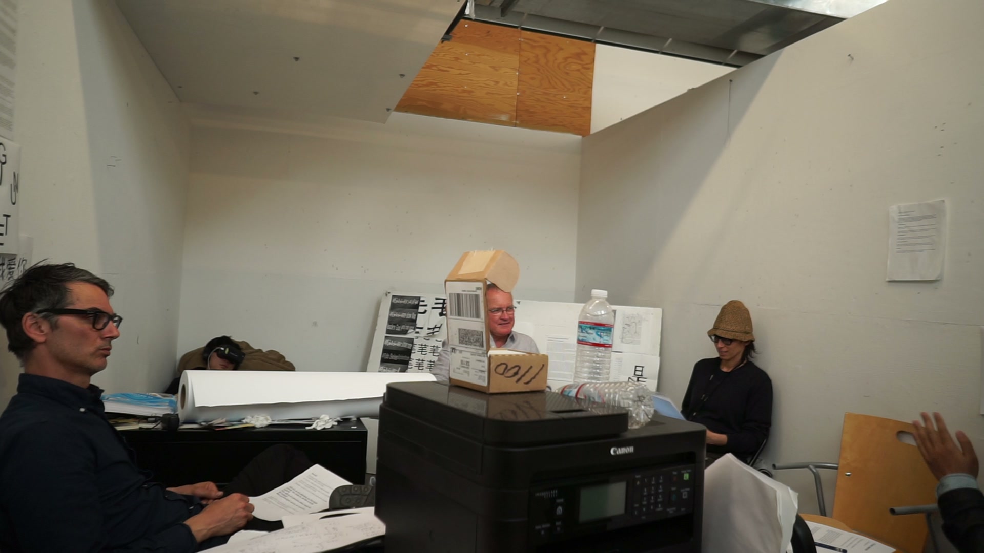 The Fa re-review studio critique, with a participant wearing VR goggles